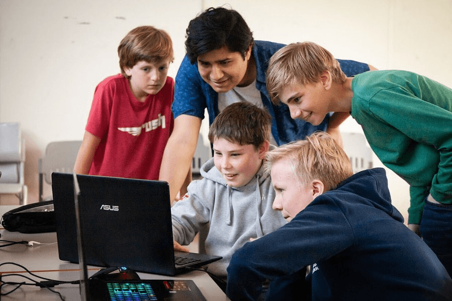 Rafid Hoda with students at a coding workshop